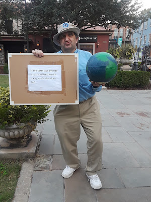 Earth scaled to the size of a basketball, illustrating the surface-based distance to the Moon